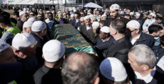 Covering the body of the deceased with a cloth upon which are verses from the Qur.aan
