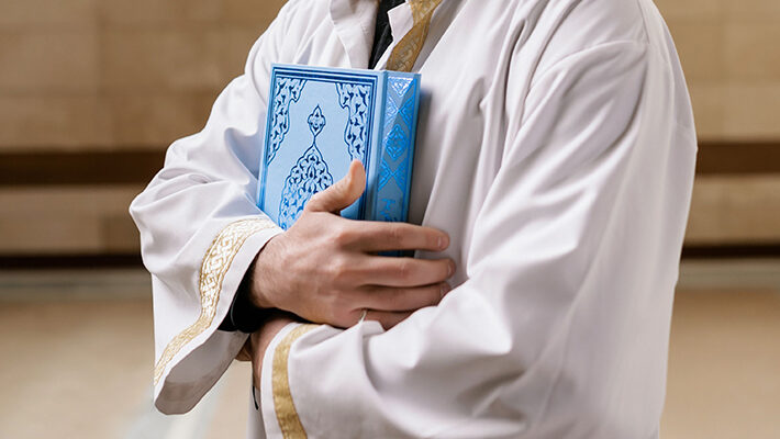 Reading the Qur.aan over the deceased and placing it on their stomach